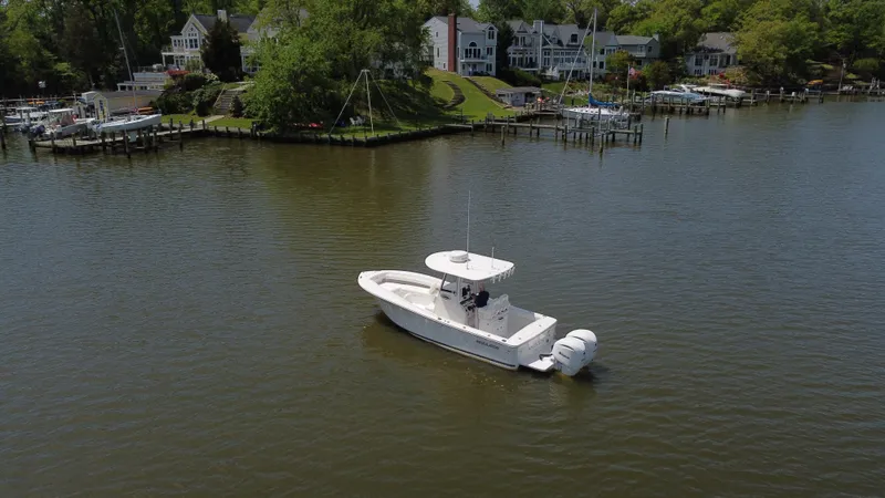Slide: The Image of 2022 Regulator 25FS boat on calm water near waterfront homes. - 9