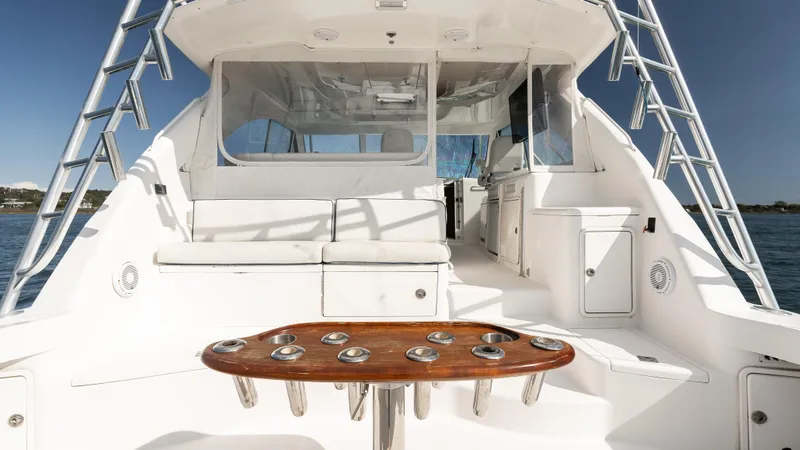 Slide: The Image of 2012 Cabo 44 HTX yacht interior with seating and fishing rod holders. - 11