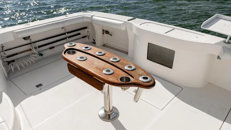 Slide: The Image of 2012 Cabo 44 HTX boat deck with rod holders and ocean view. - 17