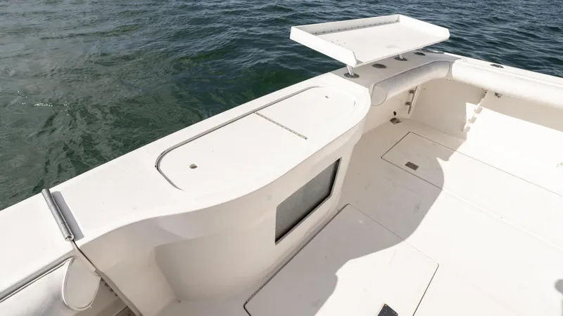 Slide: The Image of 2012 Cabo 44 HTX boat deck with clean, white finish and ocean backdrop. - 19
