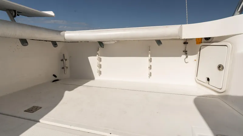 Slide: The Image of 2012 Cabo 44 HTX boat deck, spacious and clean, with storage compartments. - 21