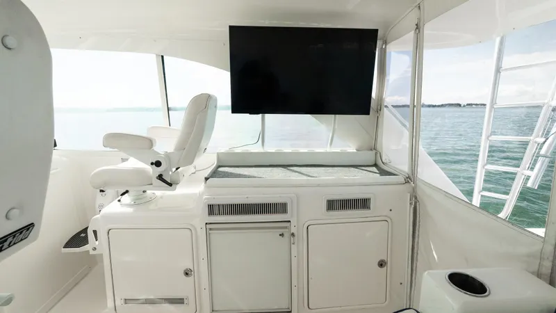Slide: The Image of Interior of 2012 Cabo 44 HTX yacht with helm seat and large screen. - 27