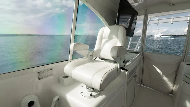 Slide: The Image of Luxury helm seat on 2012 Cabo 44 HTX yacht with scenic ocean view. - 28