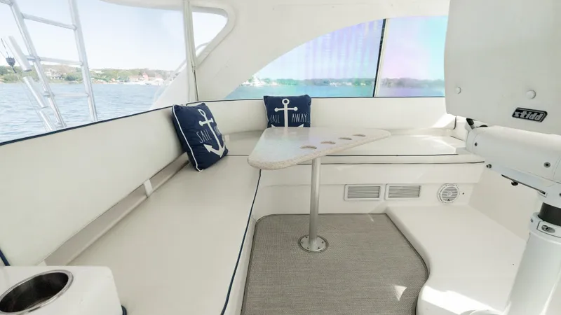 Slide: The Image of Interior of 2012 Cabo 44 HTX yacht with seating and nautical-themed cushions. - 31