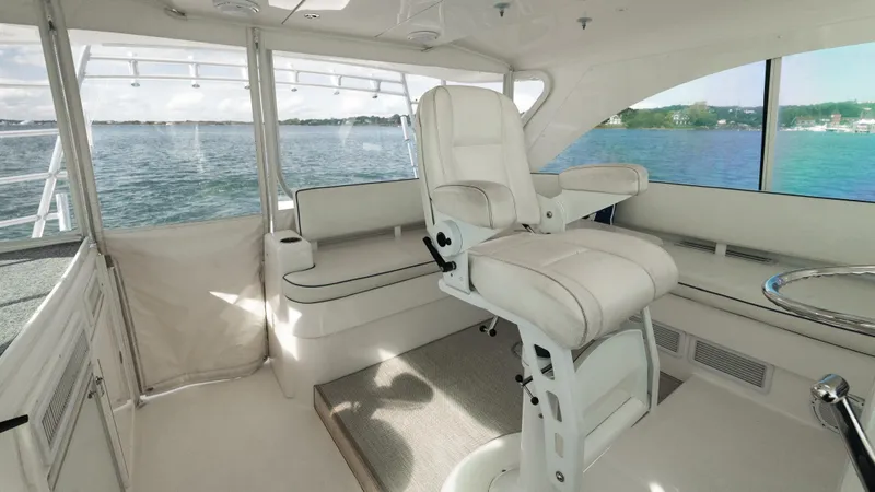 Slide: The Image of Luxurious interior of 2012 Cabo 44 HTX yacht with plush seating and scenic water view. - 32