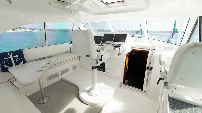 Slide: The Image of Interior of 2012 Cabo 44 HTX yacht with helm and seating area. - 33
