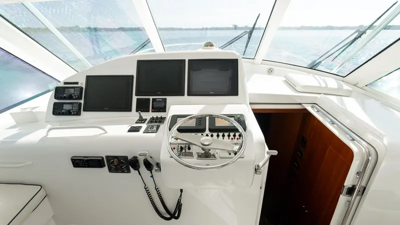 Slide: The Image of Helm of 2012 Cabo 44 HTX yacht with navigation equipment and steering wheel. - 36