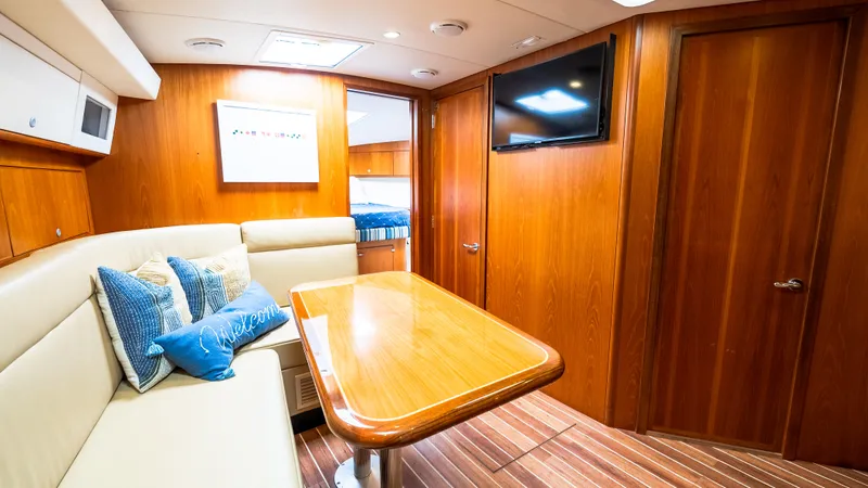 Slide: The Image of Luxurious interior of 2012 Cabo 44 HTX yacht with wood paneling and cozy seating area. - 38
