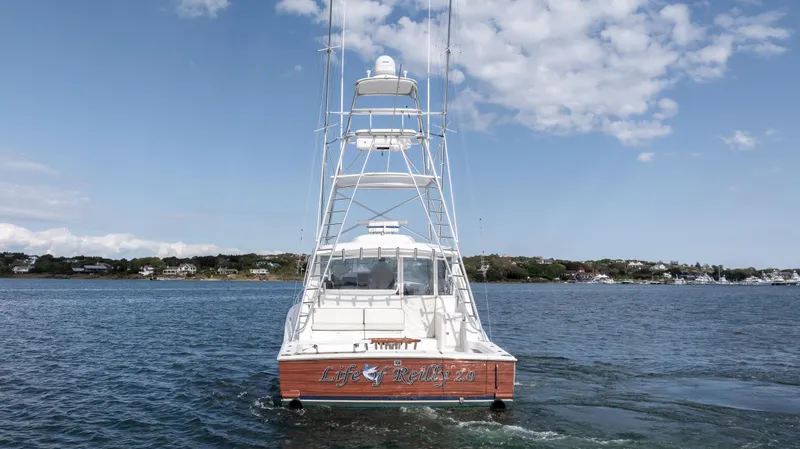 Slide: The Image of 2012 Cabo 44 HTX yacht on open water under a partly cloudy sky. - 4