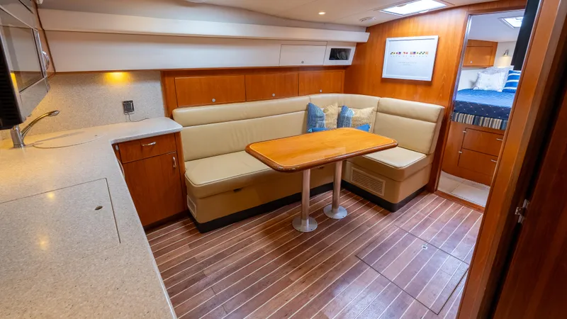 Slide: The Image of Interior of 2012 Cabo 44 HTX yacht with cozy seating and wooden flooring. - 40