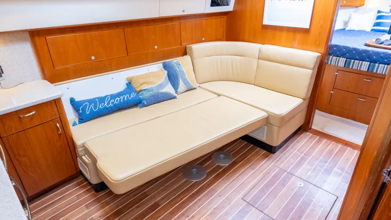 Slide: The Image of Luxurious interior of 2012 Cabo 44 HTX yacht with beige seating and wooden flooring. - 41