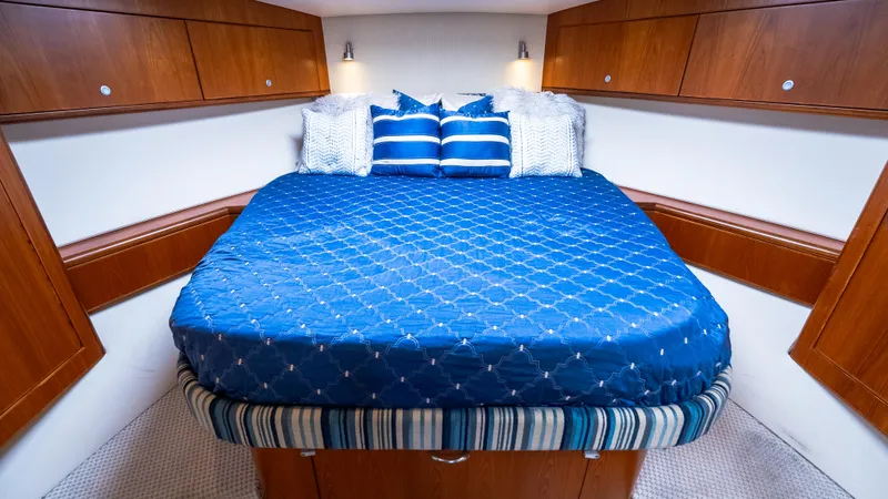 Slide: The Image of Luxurious cabin interior of 2012 Cabo 44 HTX yacht with blue bedding. - 44