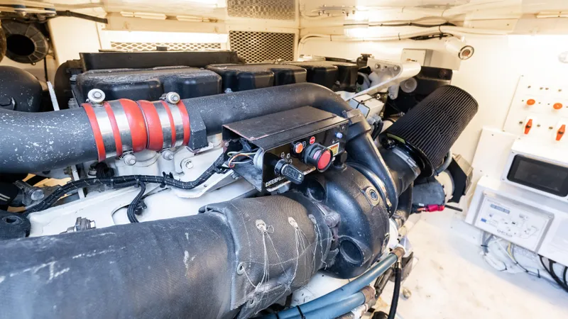 Slide: The Image of Engine room of 2012 Cabo 44 HTX yacht, showcasing detailed machinery and components. - 49