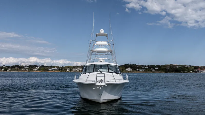 Slide: The Image of 2012 Cabo 44 HTX yacht on calm water under blue sky. - 8
