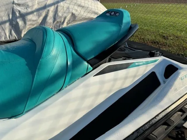 Slide: The Image of 2021 Sea-Doo GTI 90 jet ski with teal seat and white body. - 2