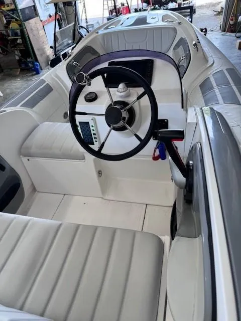 Slide: The Image of 2023 Flexboat Flex 450 interior, featuring steering wheel and seating in a sleek design. - 4