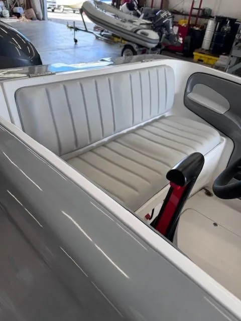 Slide: The Image of 2023 Flexboat Flex 450 interior with white seating in a showroom. - 5