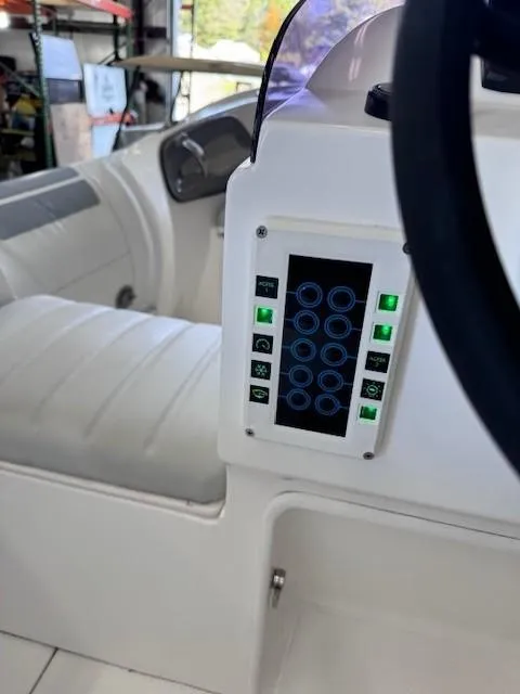 Slide: The Image of 2023 Flexboat Flex 450 interior dashboard with control panel and seating. - 6