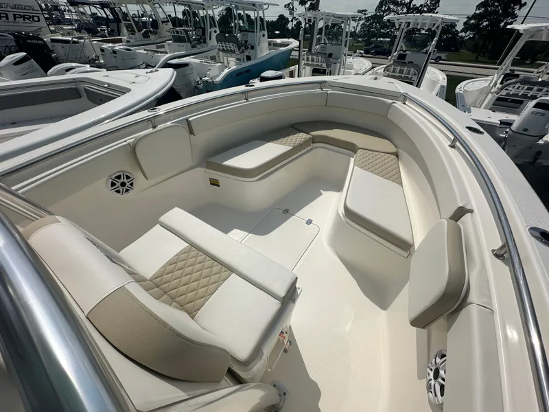 Slide: The Image of 2025 Bulls Bay 255 CC boat interior with cushioned seating and modern design. - 5