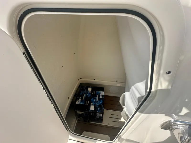 Slide: The Image of Storage compartment of 2025 Bulls Bay 255 CC boat with boxes inside. - 7