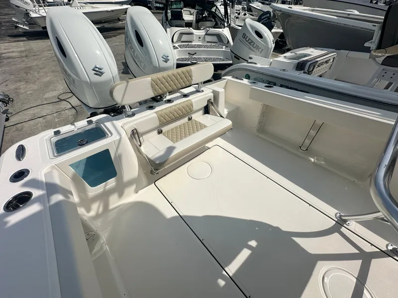 Slide: The Image of 2025 Bulls Bay 255 CC boat interior with dual Suzuki engines, spacious deck, and seating. - 9