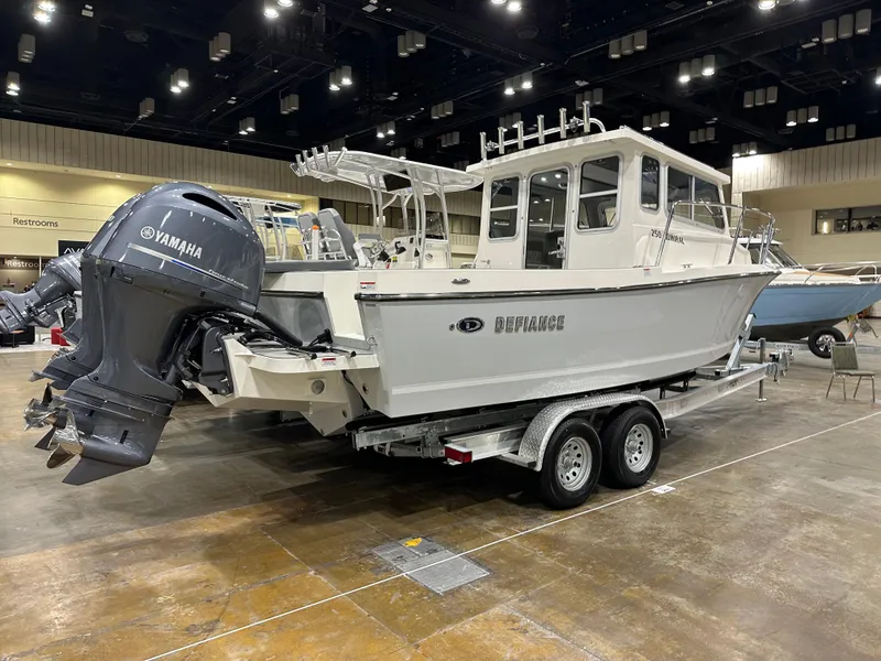 Slide: The Image of 2026 Defiance Admiral 250 EX boat with Yamaha engine on display indoors. - 2