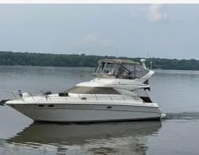 Slide: The Image of 1997 Sea Ray 400 Sedan Bridge yacht cruising on calm waters. - 1