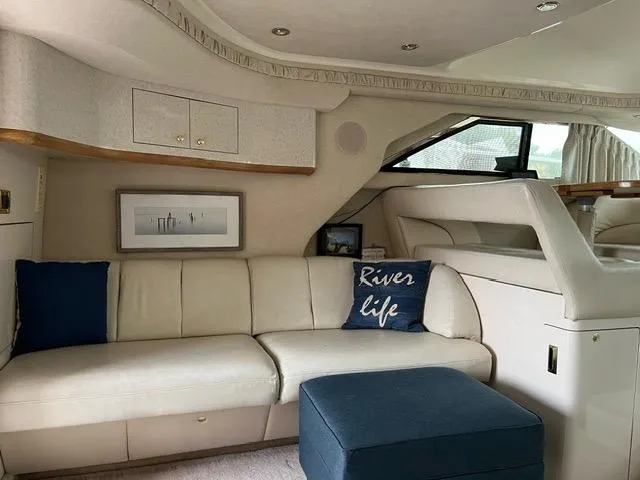 Slide: The Image of Interior of 1997 Sea Ray 400 Sedan Bridge with cream sofa and nautical decor. - 11