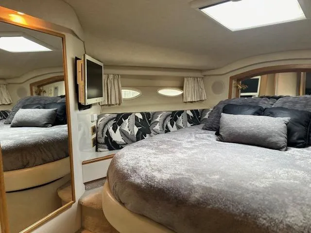 Slide: The Image of Luxurious 1997 Sea Ray 400 Sedan Bridge bedroom with plush bedding and elegant decor. - 14