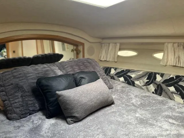 Slide: The Image of Cozy bedroom interior of 1997 Sea Ray 400 Sedan Bridge yacht with plush bedding. - 15