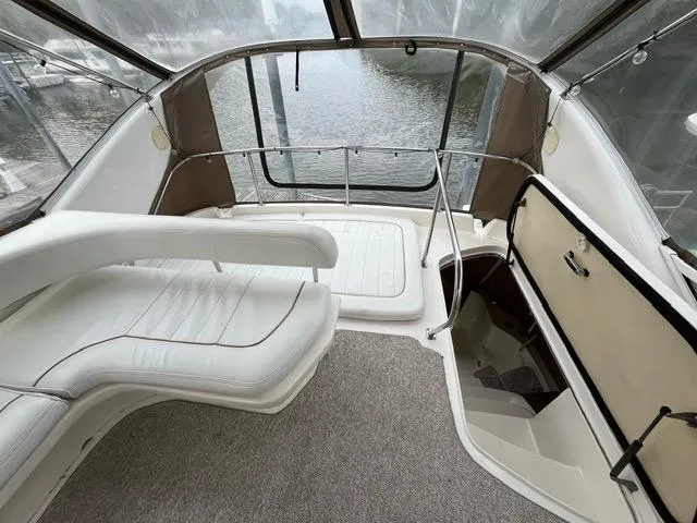 Slide: The Image of 1997 Sea Ray 400 Sedan Bridge interior with white seating and water view. - 17