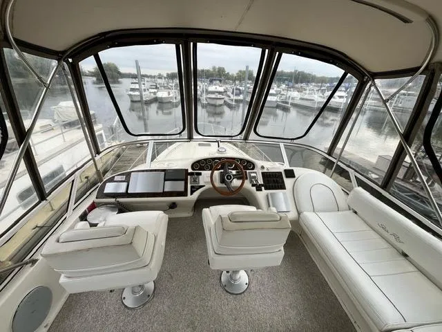 Slide: The Image of Interior view of 1997 Sea Ray 400 Sedan Bridge yacht cockpit with marina background. - 19