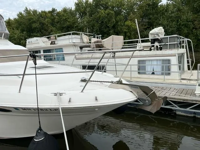 Slide: The Image of 1997 Sea Ray 400 Sedan Bridge docked near other boats. - 21