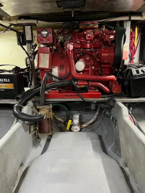Slide: The Image of Engine compartment of 1997 Sea Ray 400 Sedan Bridge with red machinery and wiring. - 22
