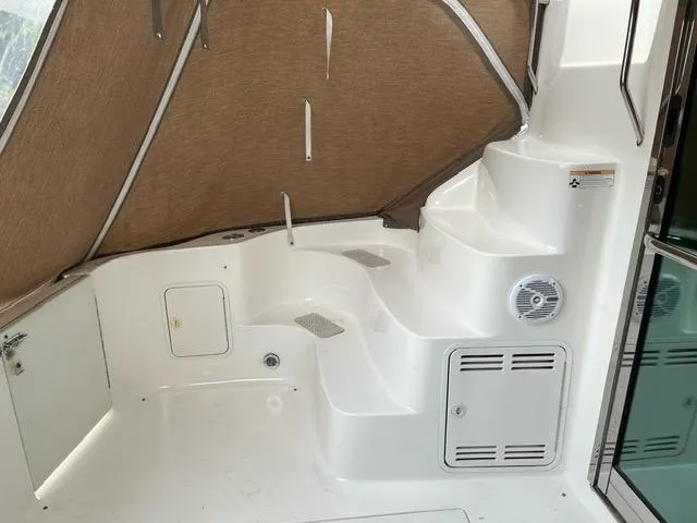 Slide: The Image of 1997 Sea Ray 400 Sedan Bridge interior with white steps and tan canopy. - 6