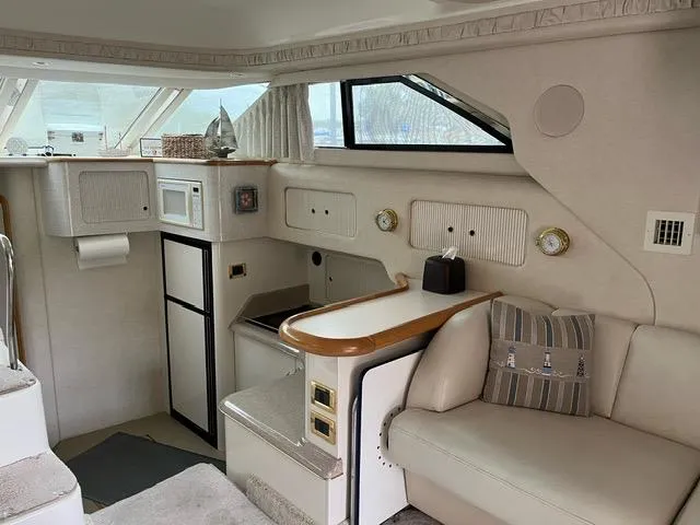 Slide: The Image of Interior of 1997 Sea Ray 400 Sedan Bridge yacht with modern amenities. - 7