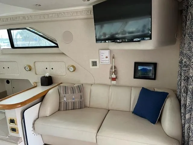 Slide: The Image of Interior of 1997 Sea Ray 400 Sedan Bridge with sofa, TV, and window view. - 8