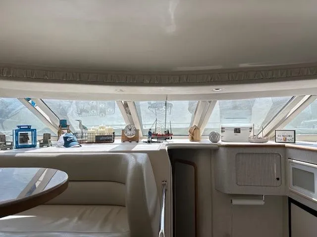 Slide: The Image of Interior of 1997 Sea Ray 400 Sedan Bridge yacht with panoramic windows and elegant decor. - 9