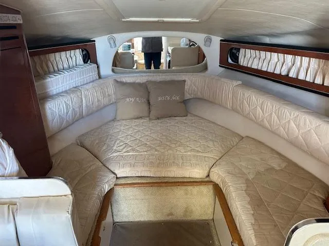 Slide: The Image of Interior of 2003 Sea Ray 280 Sundancer with beige seating and cushions. - 11