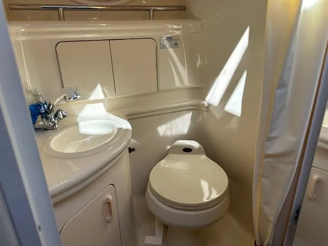 Slide: The Image of 2003 Sea Ray 280 Sundancer bathroom with sink and toilet. - 14