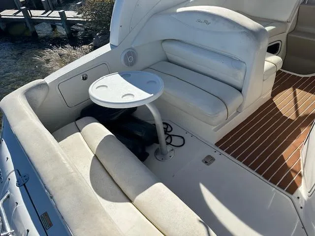Slide: The Image of 2003 Sea Ray 280 Sundancer boat interior with seating and table. - 4