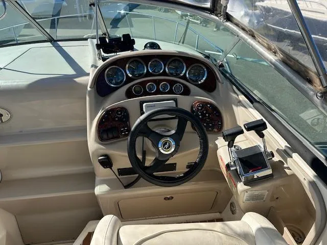 Slide: The Image of 2003 Sea Ray 280 Sundancer helm with steering wheel and instrument panel. - 7