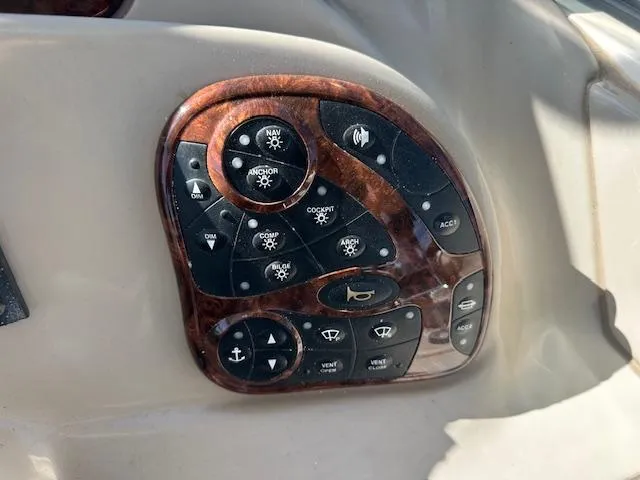 Slide: The Image of Control panel of a 2003 Sea Ray 280 Sundancer boat with woodgrain finish. - 9