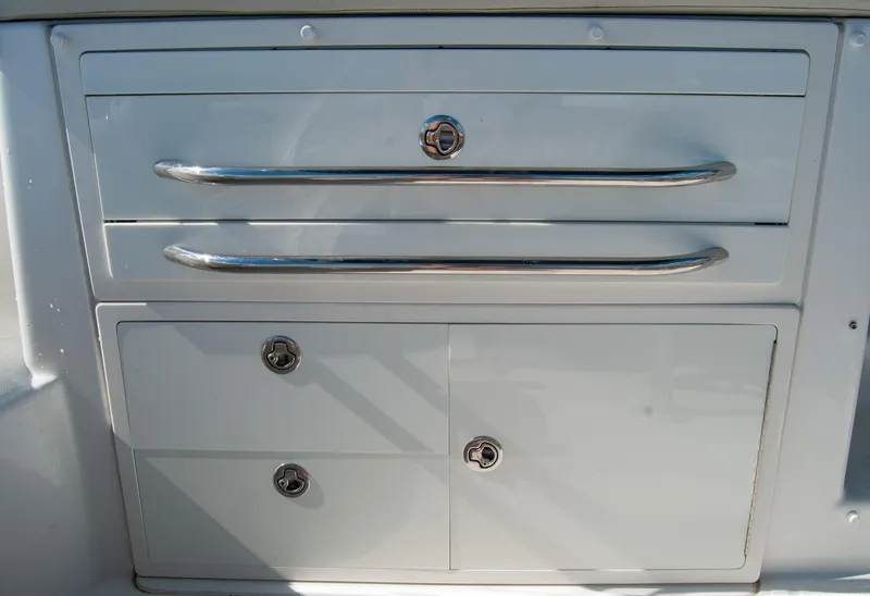 Slide: The Image of Storage compartment on a 2021 Boston Whaler 345 Conquest boat with sleek metal handles. - 12