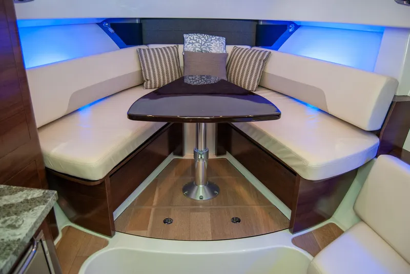 Slide: The Image of Interior of 2021 Boston Whaler 345 Conquest with cushioned seating and table. - 18