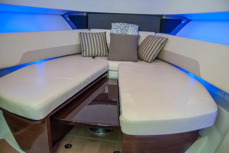 Slide: The Image of 2021 Boston Whaler 345 Conquest interior with plush seating and ambient lighting. - 19