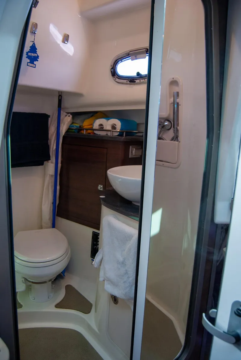Slide: The Image of 2021 Boston Whaler 345 Conquest bathroom with toilet, sink, and storage. - 24