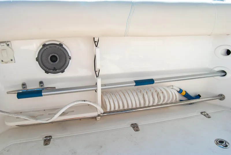 Slide: The Image of 2021 Boston Whaler 345 Conquest deck storage with speaker and coiled hose. - 35