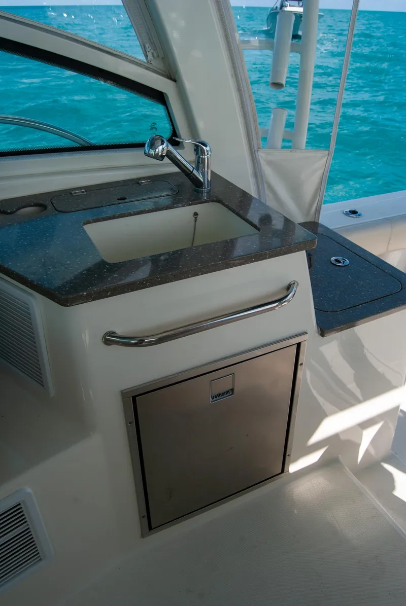 Slide: The Image of 2021 Boston Whaler 345 Conquest boat interior with sink and countertop. - 45
