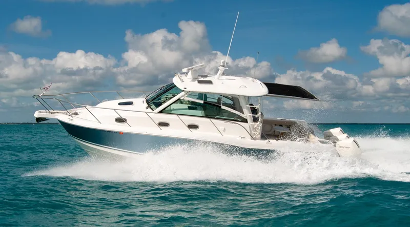 Slide: The Image of 2021 Boston Whaler 345 Conquest cruising on clear blue ocean under a sunny sky. - 46